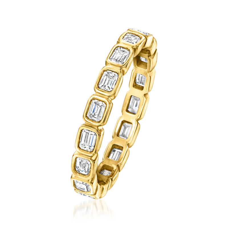 Gold eternity band angled view with emerald-cut diamonds in gold bezel settings