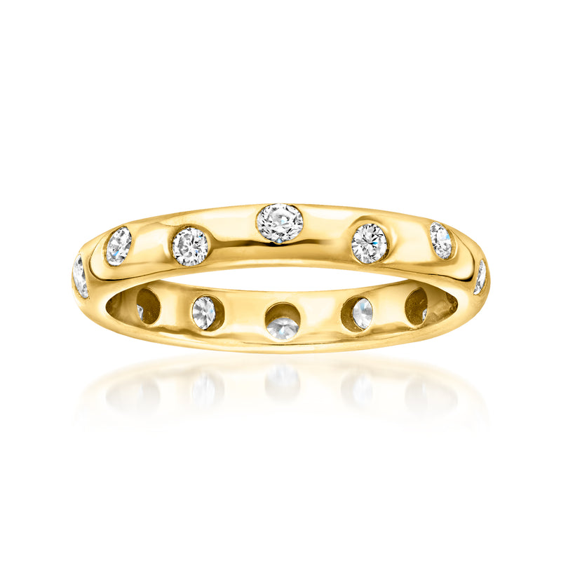 Gold eternity band with scattered round diamonds on top and in side settings