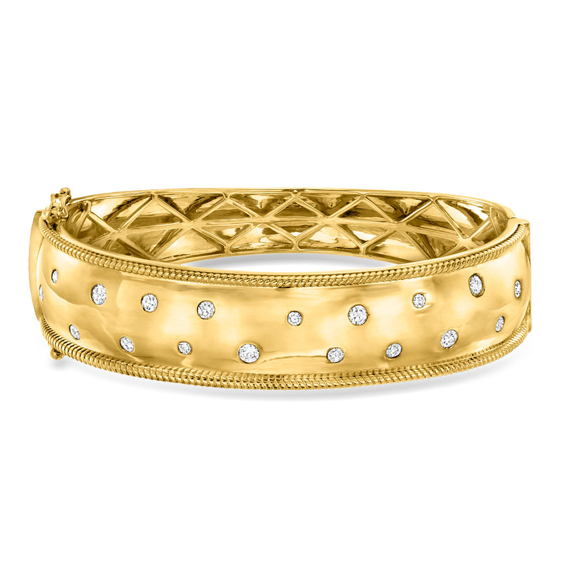 Gold bangle bracelet with scattered round diamonds on perforated textured band