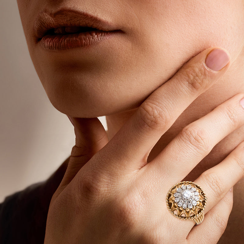 Vintage gold diamond cluster ring on hand, round center stone in scalloped halo