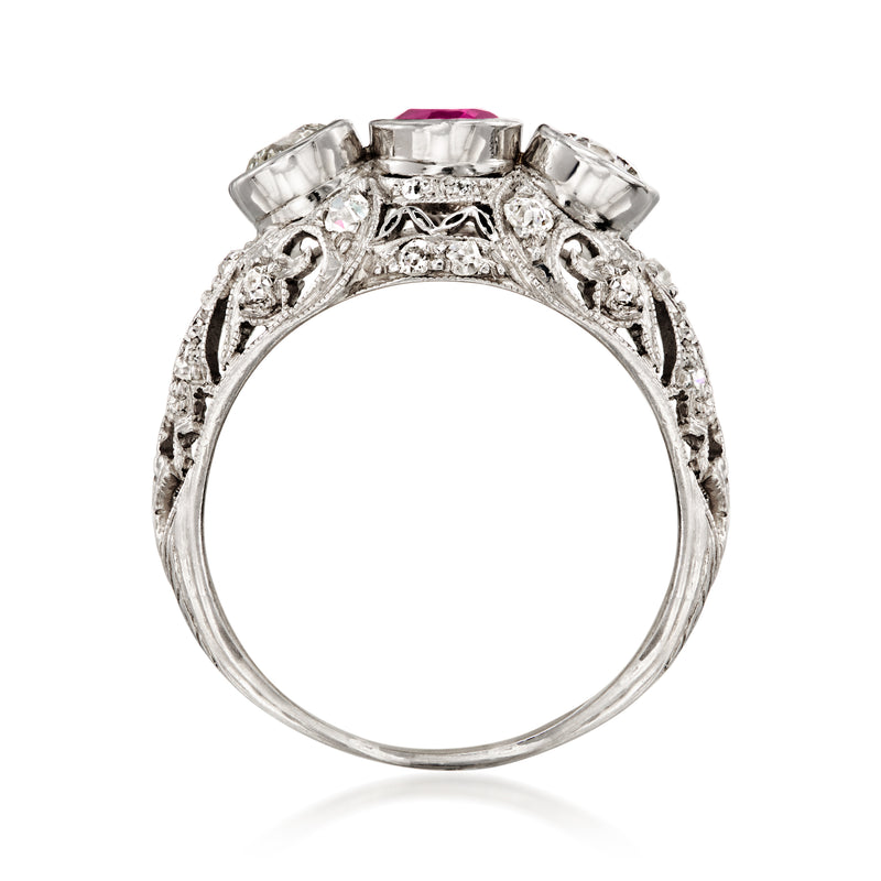 Platinum ring band with ornate filigree setting and pink oval gemstone top view
