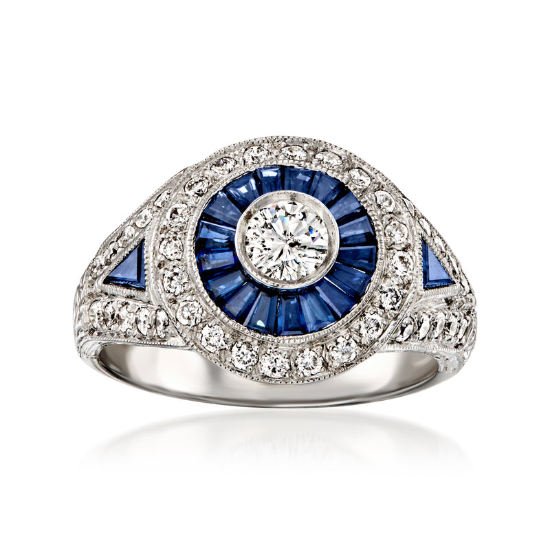 Geometric 18kt white gold ring with round diamond center and blue sapphire halo
