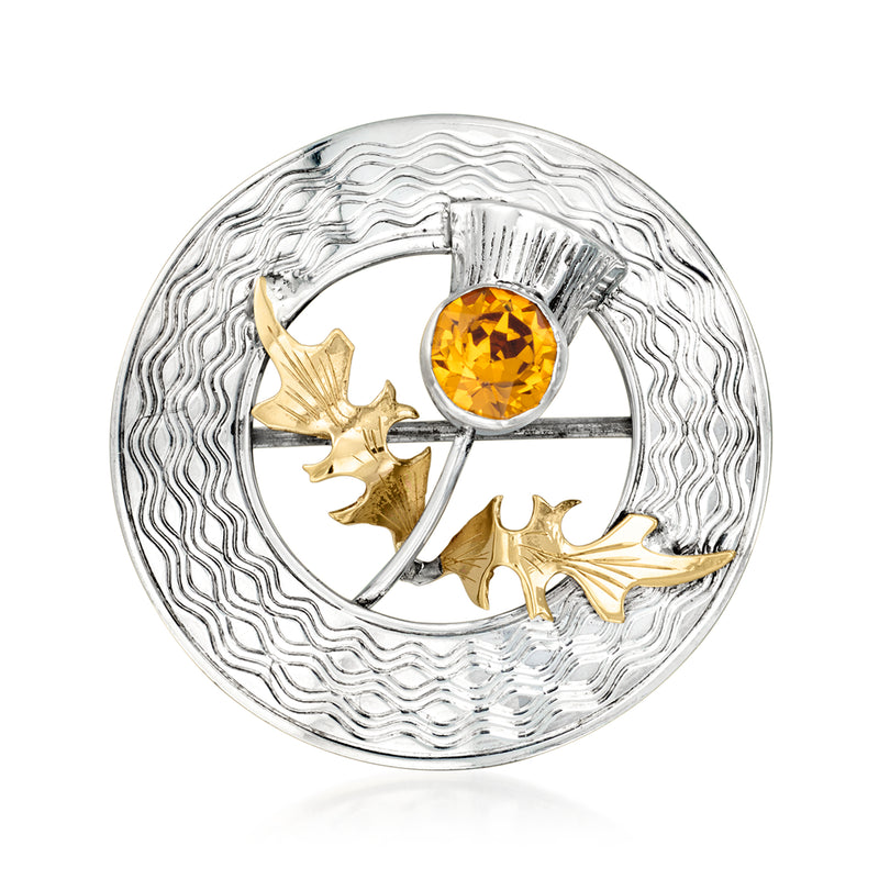 Vintage sterling silver thistle pin with round textured bezel and orange simulated crystal