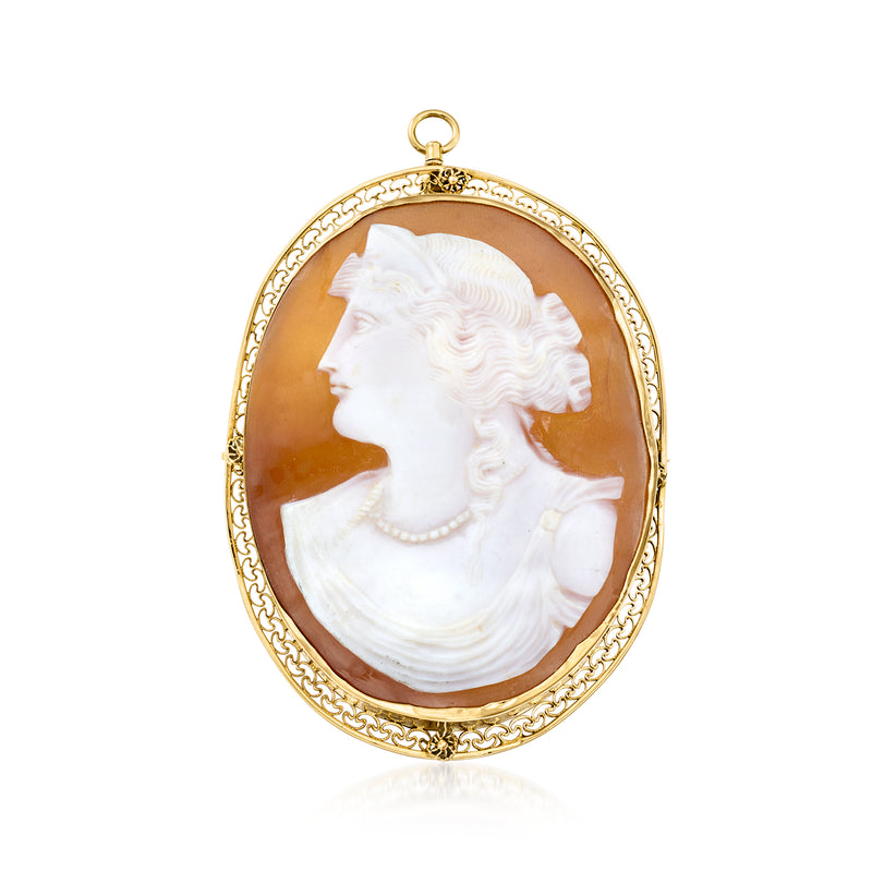 Oval cameo pendant with white left-facing profile in brown shell, gold frame