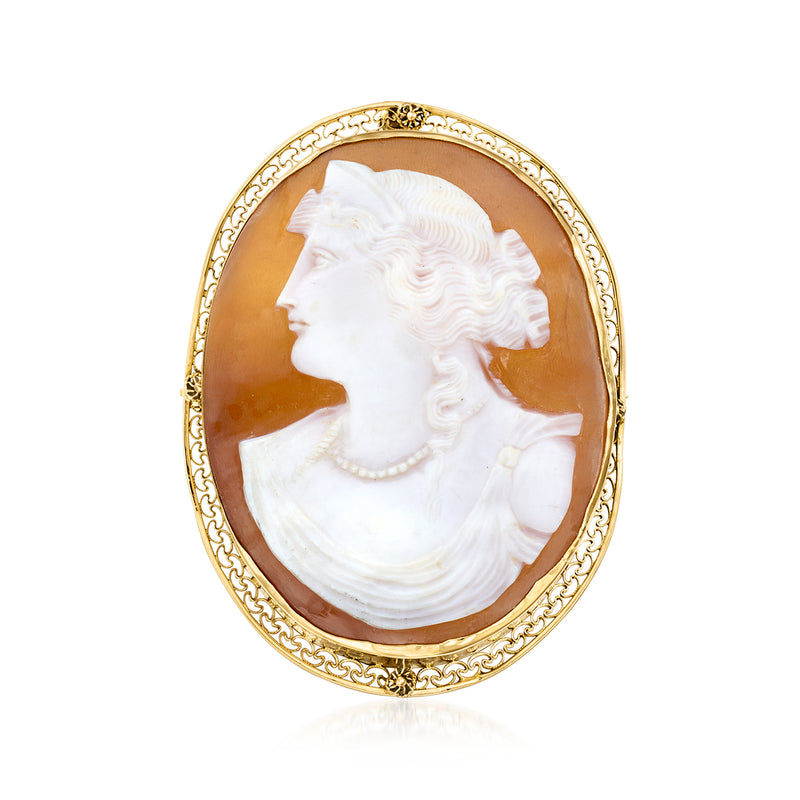 Gold oval cameo pendant with white left-facing profile set in brown shell backing