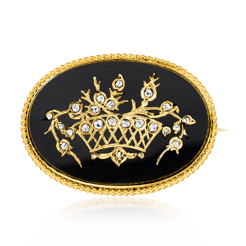 Oval black onyx pin with gold flower basket design and diamond-like accents