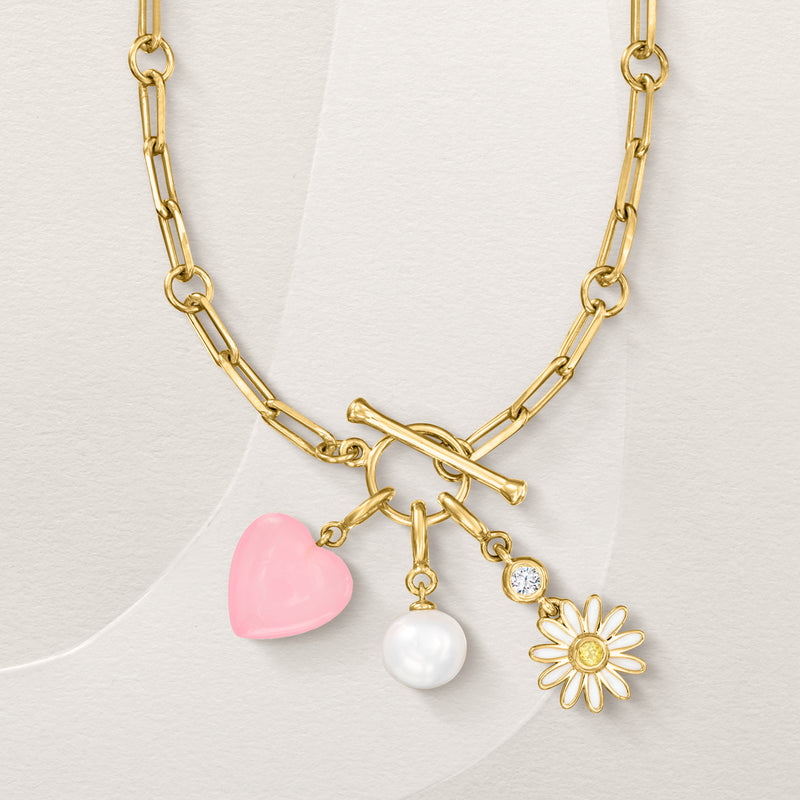 Gold charm necklace with pink heart, white pearl bead, and flower accent