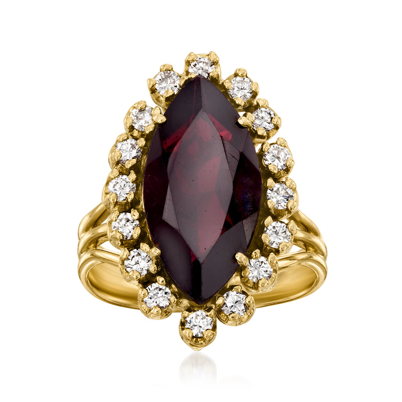 Yellow gold cocktail ring with marquise garnet center and round diamond halo.