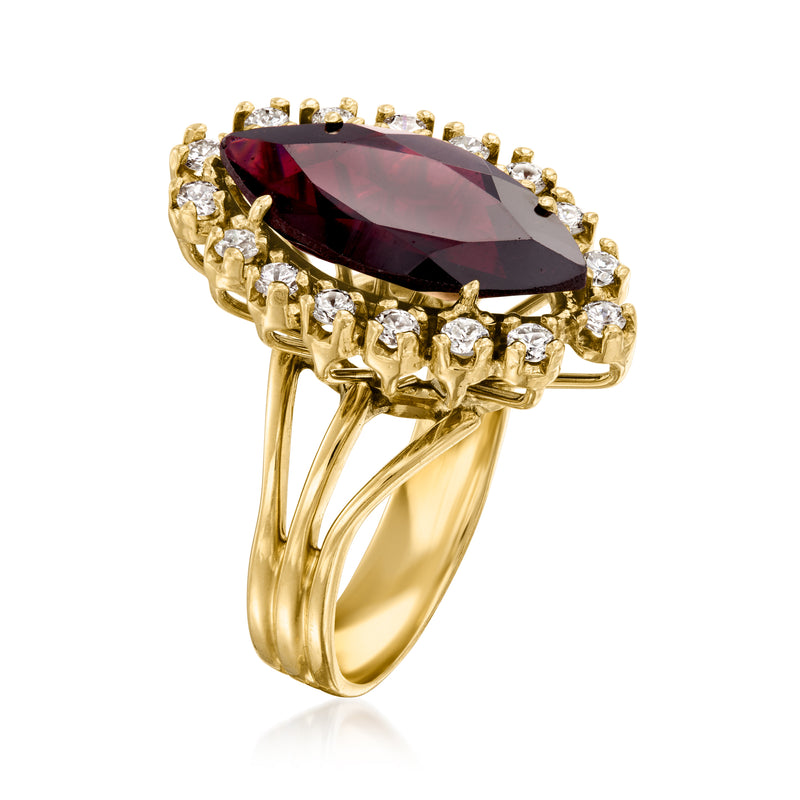 14k yellow gold ring with marquise garnet and round diamond halo, side angle view.