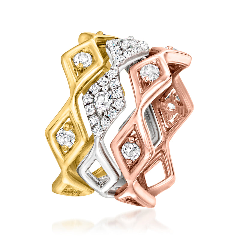 Zigzag rings stacked in gold, silver, and rose with round white stones