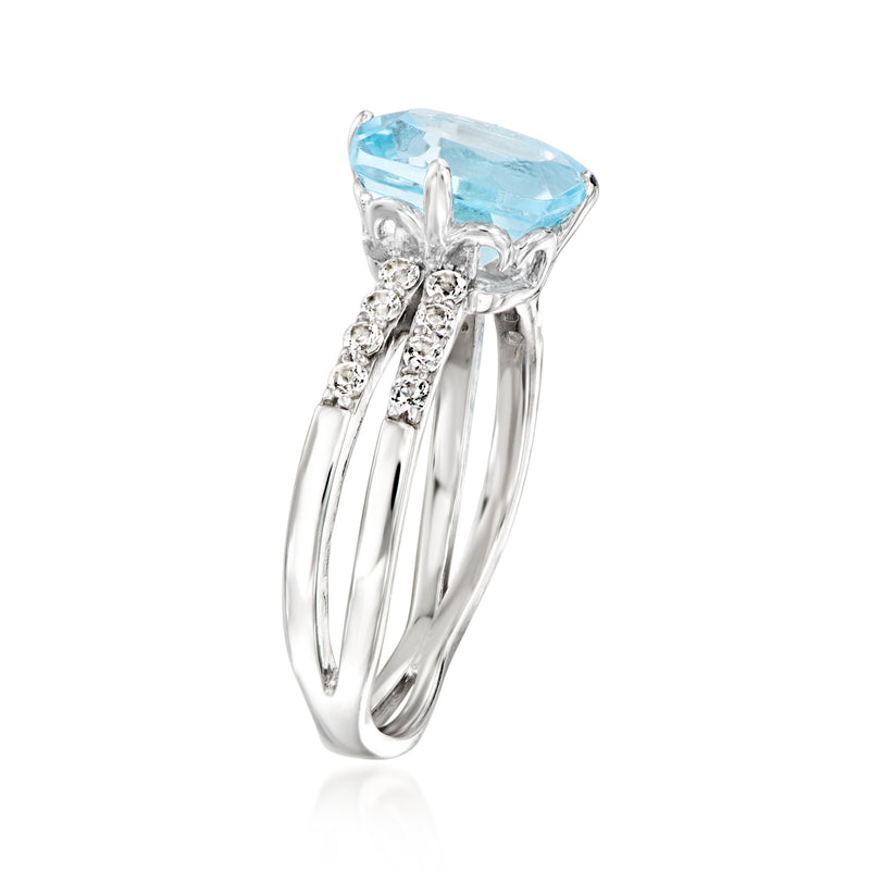 Sterling silver ring angled view; sky blue topaz with prong-set white stone accents
