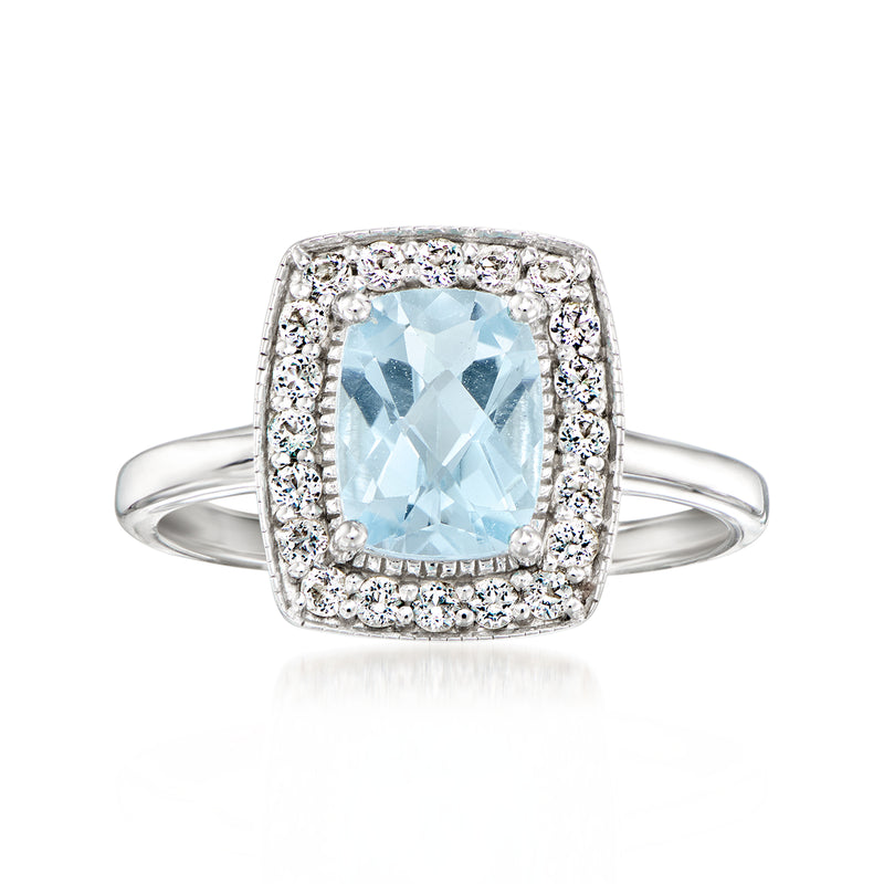 Sterling silver ring with sky blue topaz center and white stone halo, open band
