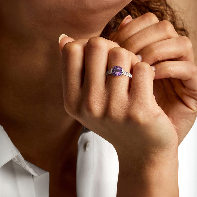 Sterling silver ring with purple amethyst cushion center and thin diamond-studded band