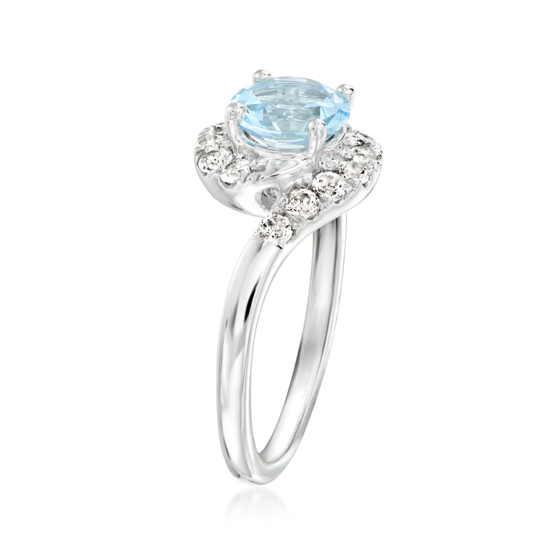 Sterling silver ring with oval sky blue topaz and white gemstone halo, side view