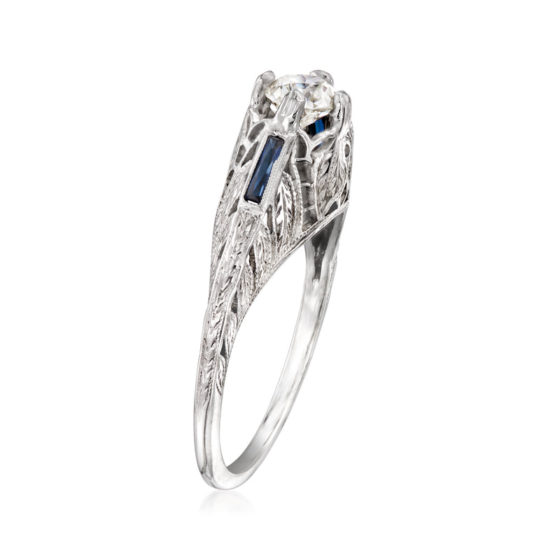 Vintage white gold diamond ring with ornate filigree and blue sapphire side stones