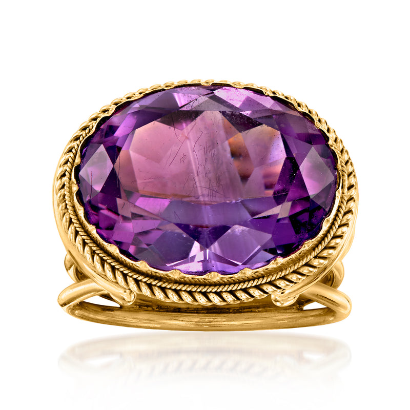 Amethyst cocktail ring in 18kt yellow gold with large oval purple gemstone.