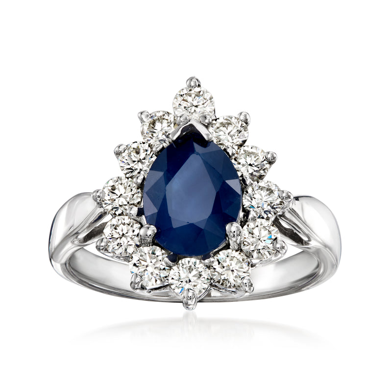 White gold sapphire and diamond ring with oval deep blue center stone and round halos