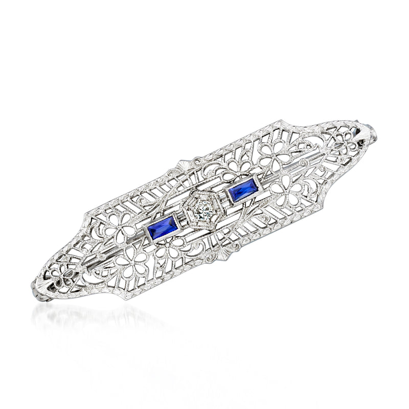 Vintage white gold filigree pin with blue synthetic sapphire and small diamond accents