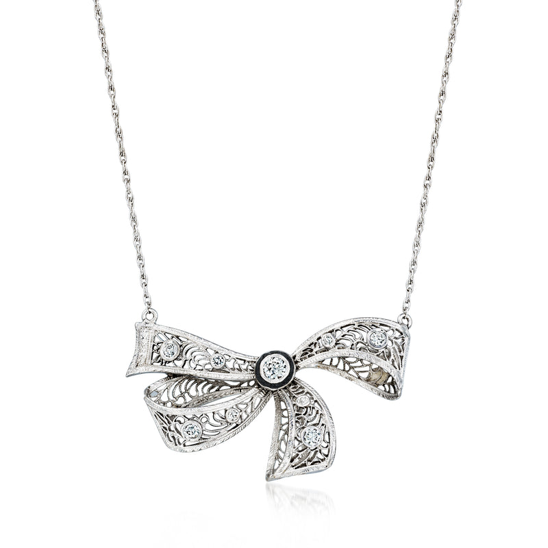 Bow diamond necklace with filigree ribbon design and round center stone on a silver chain
