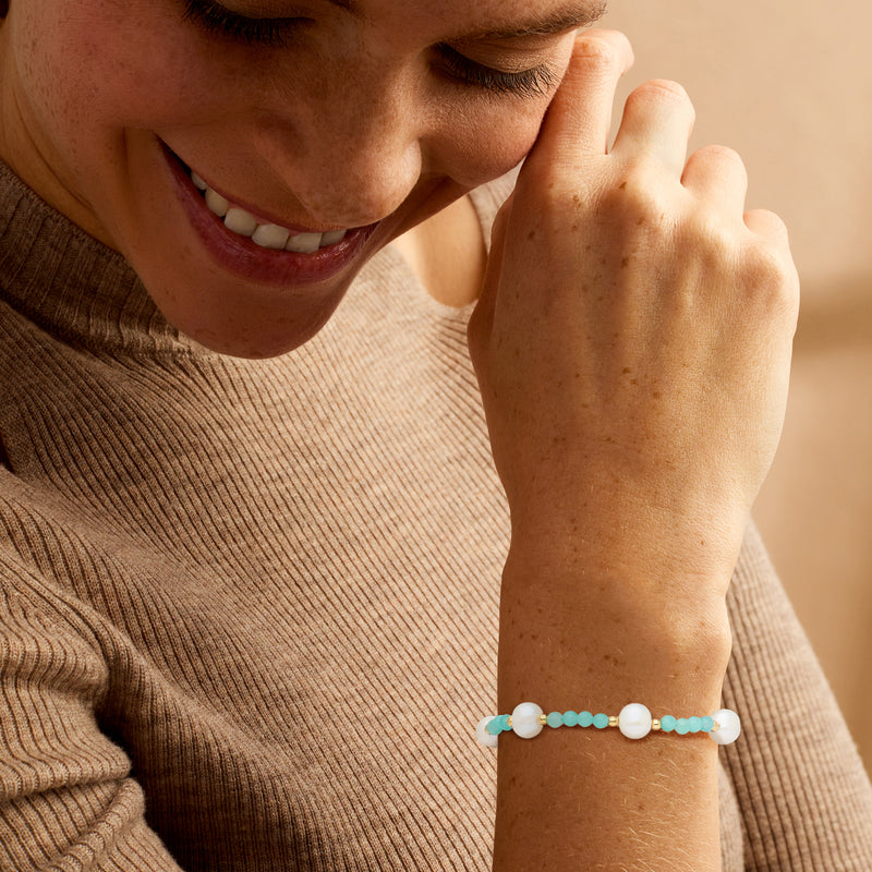 Cultured pearl and amazonite bead bracelet on wrist with gold clasp