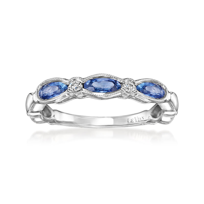 Three-stone oval blue sapphire ring with round white diamonds in prong settings