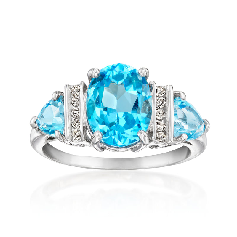 Vintage blue topaz ring in white gold with large oval center stone and side blue stones