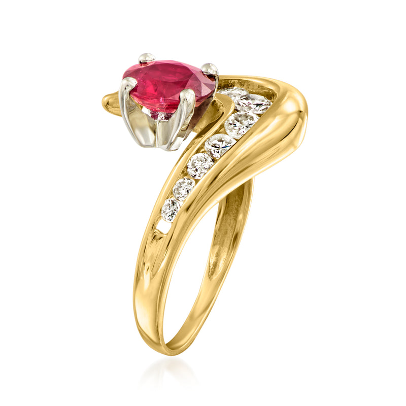 Yellow gold swirl ring with red oval ruby bezel and round diamond side stones