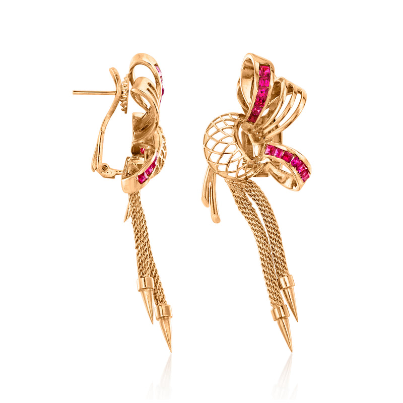 Rose gold drop earrings with pink-red stones, curved ribbon loops, and long tassel drops