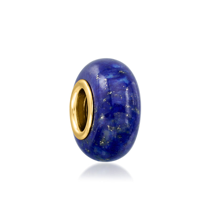 Oval lapis lazuli charm bead with gold-toned metal rim, blue speckled stone