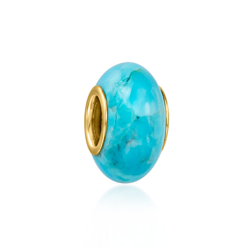 Turquoise oval bead charm with gold-tone end ring and polished bezel