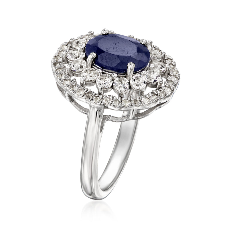Sterling silver ring with oval blue sapphire center and prong-set white stones halo