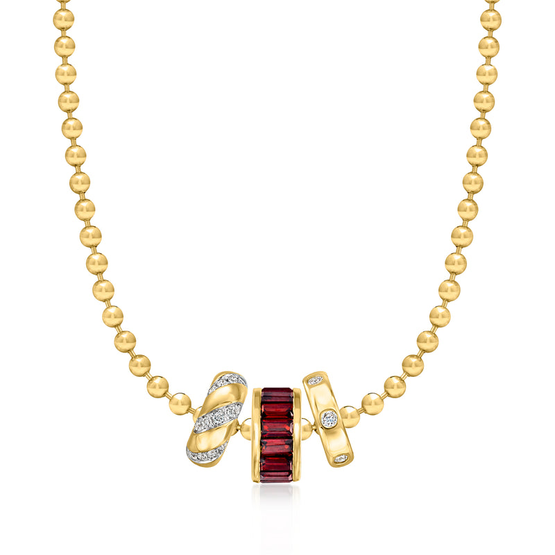 Gold beaded necklace with red baguette birthstone charm and small sparkling accents