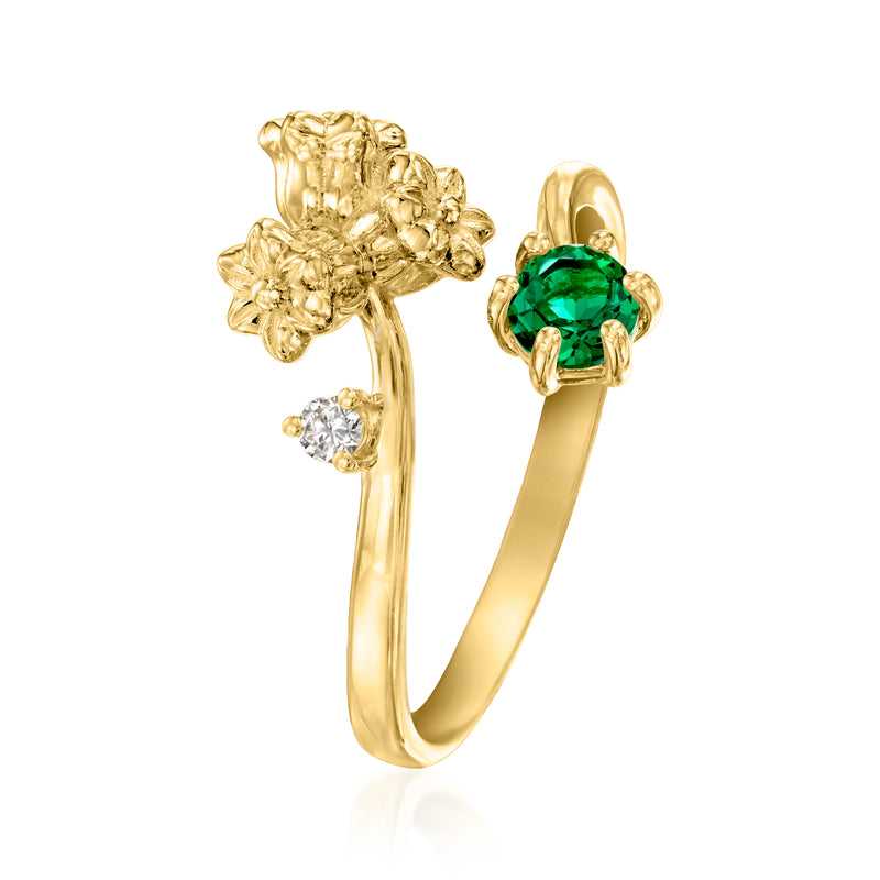 Gold lily of the valley ring side view with green bezel-set emerald and diamond stones