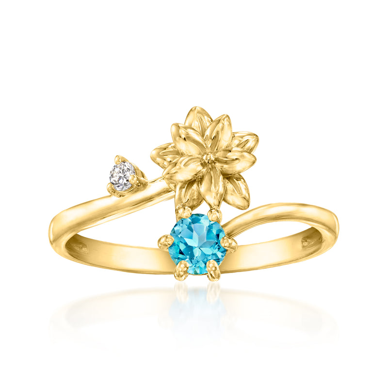 Gold-tone poinsettia flower ring with blue oval gemstone and small diamond accents