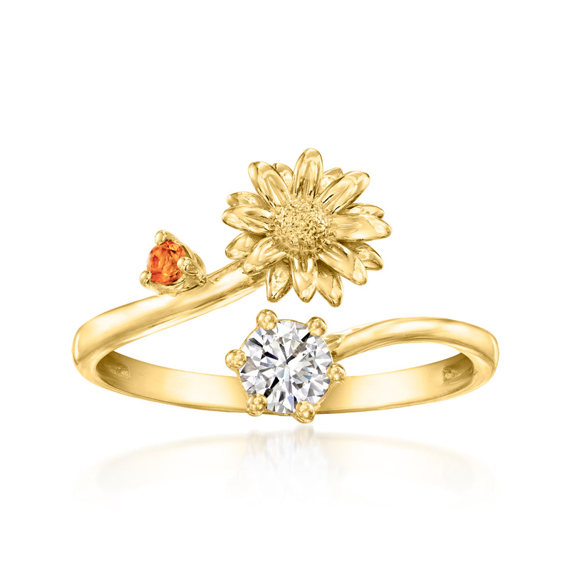 Gold daisy-style ring with round clear center stone and small orange side gem