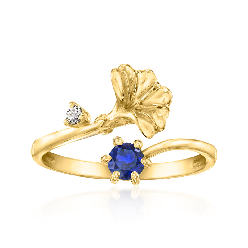 Gold-tone floral ring with round blue sapphire center and small diamond accents
