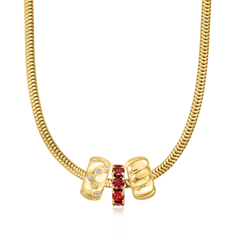 Gold snake chain necklace with bead charm, red centerpiece gemstone and clear stones