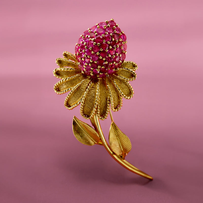 Yellow gold flower pin with round pink ruby stone cluster and layered leaf petals.