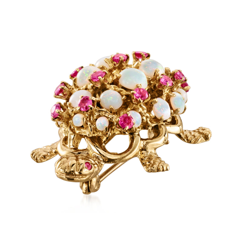 Gold turtle pin with opal-like stones and pink ruby gemstones, side view