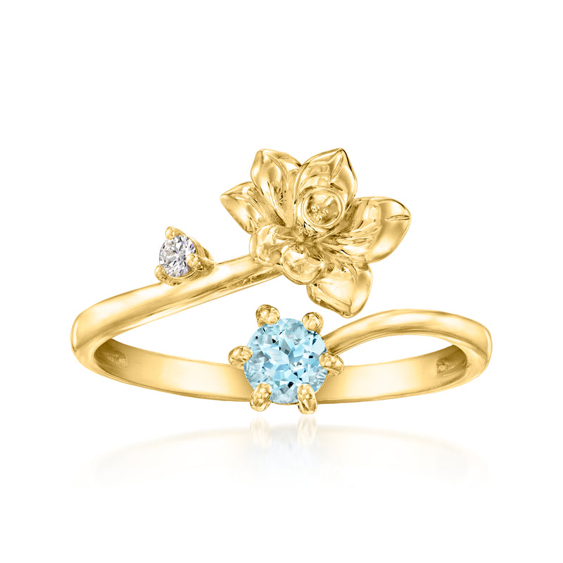 Gold flower ring with blue aquamarine center and small diamond accents