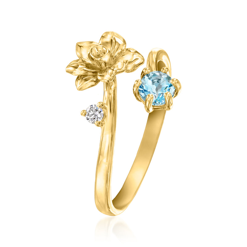 Gold flower ring with round blue aquamarine center and two diamond side stones