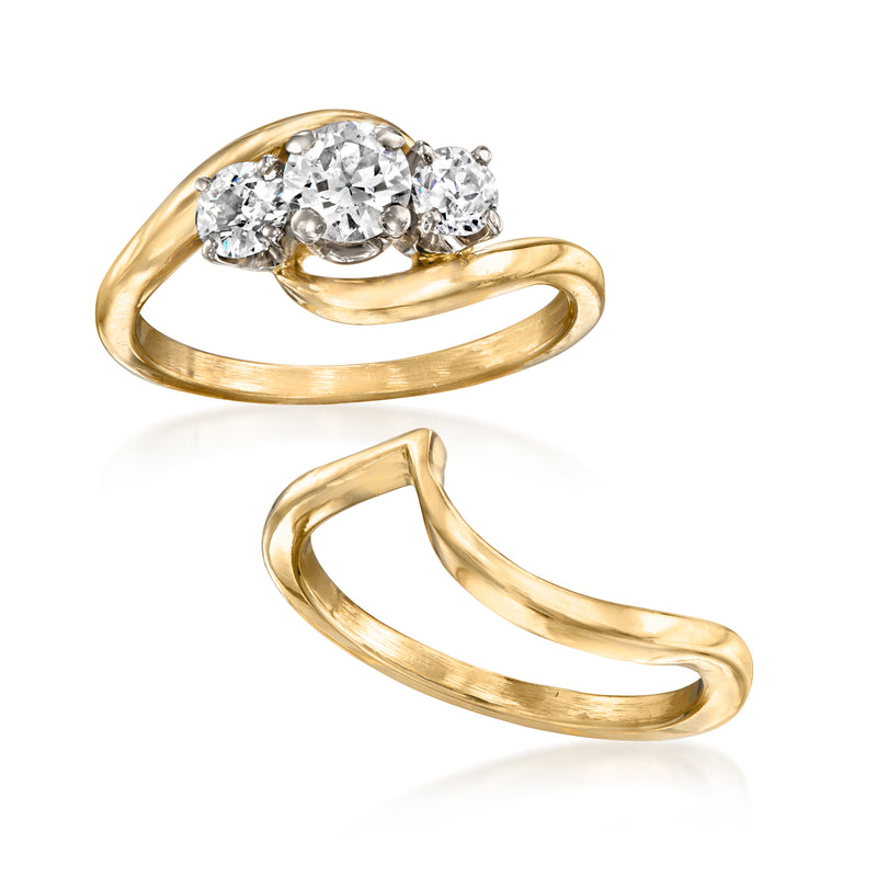 Vintage yellow gold three-diamond ring with curved matching wedding band, angled view