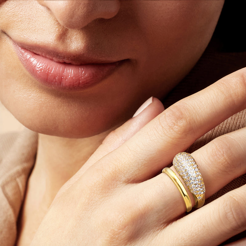 14kt yellow gold-plated bypass ring with pavé CZs on a hand