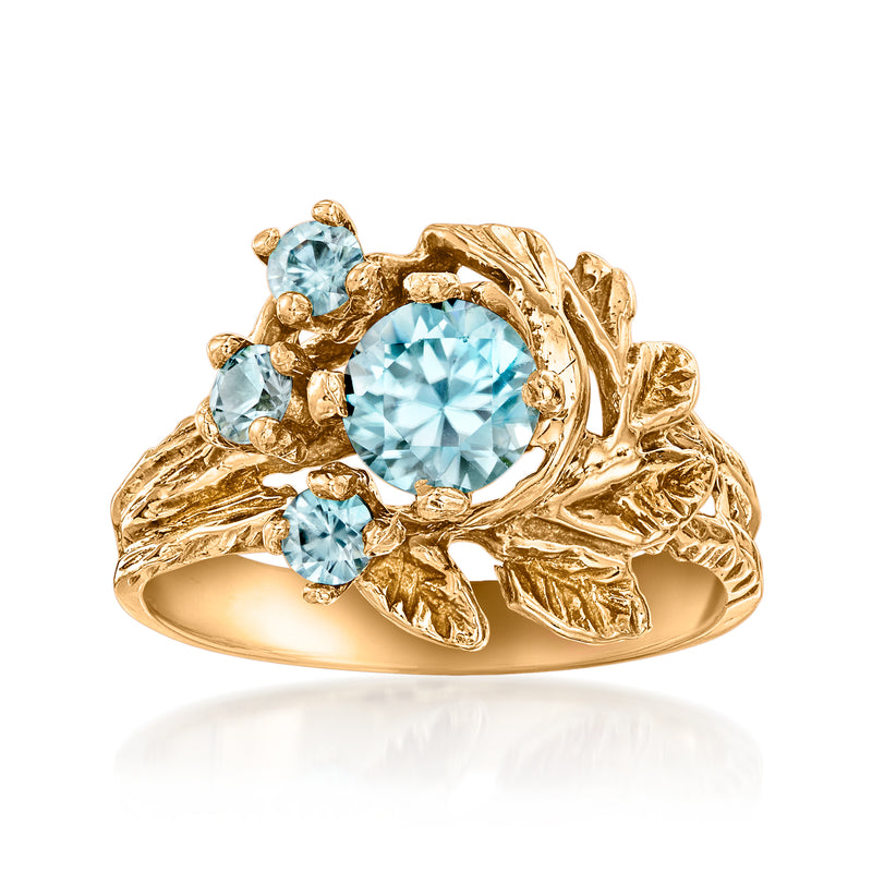 Blue zircon flower ring in 10kt yellow gold with round center stone and 4 accents