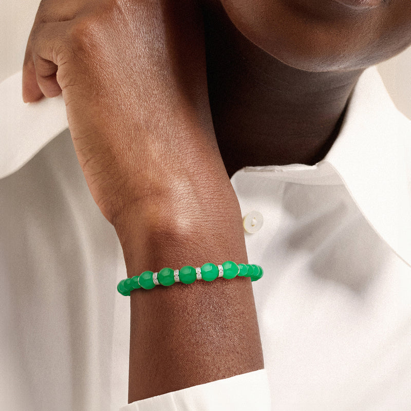 Green jade bead stretch bracelet on wrist, with silver diamond accents