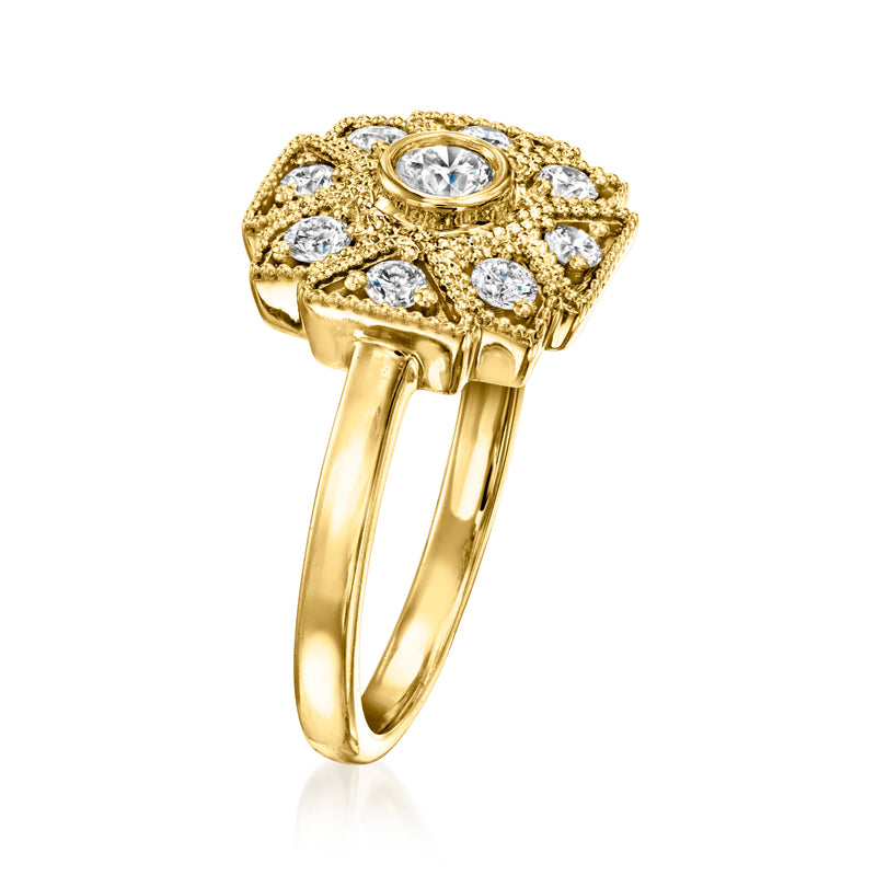 Gold art deco diamond-look ring with raised bezel center and round halo stones, slim band