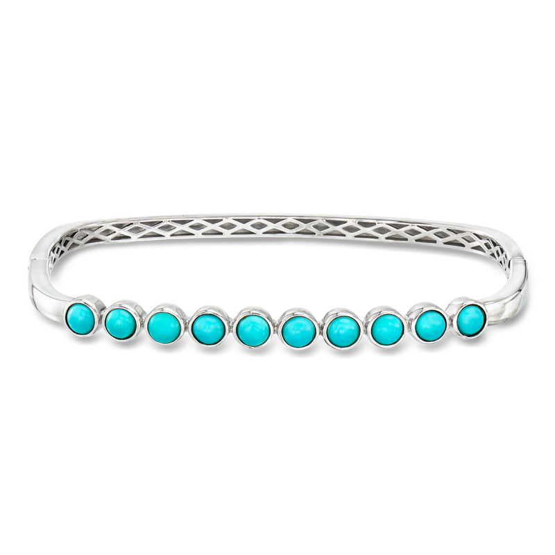 Sterling silver bangle bracelet with turquoise round beads along the cuff