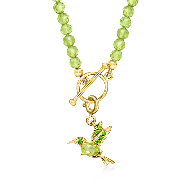 Hummingbird charm dangling from gold-tone clasp on green bead chain