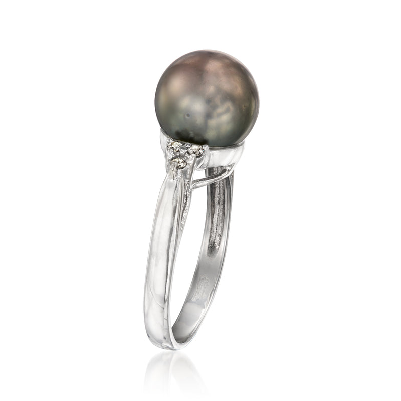 White gold ring with round dark pearl top, diamonds set around the pearl setting