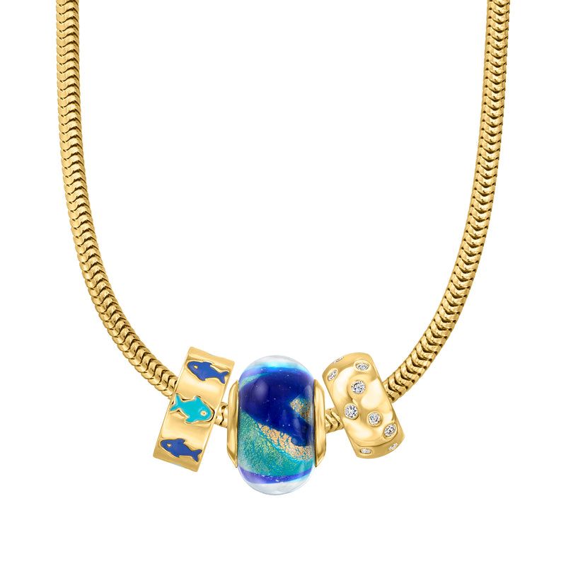 Gold chain necklace featuring blue Murano glass bead charm with gold and crystal accents